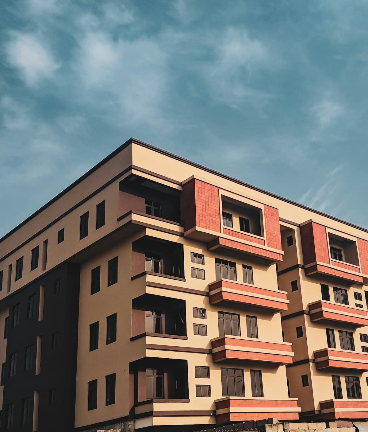 A multi-storey apartment building against a blue sky