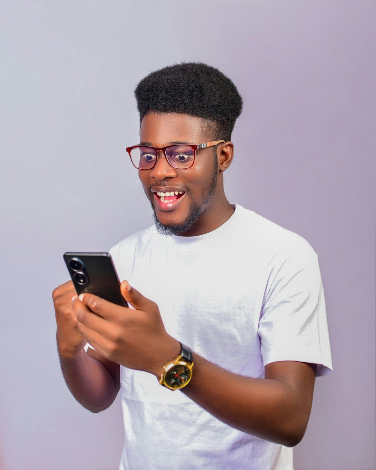 A smiling man reading good news on his phone